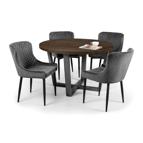 Round wooden dining table with four gray upholstered chairs on a white background