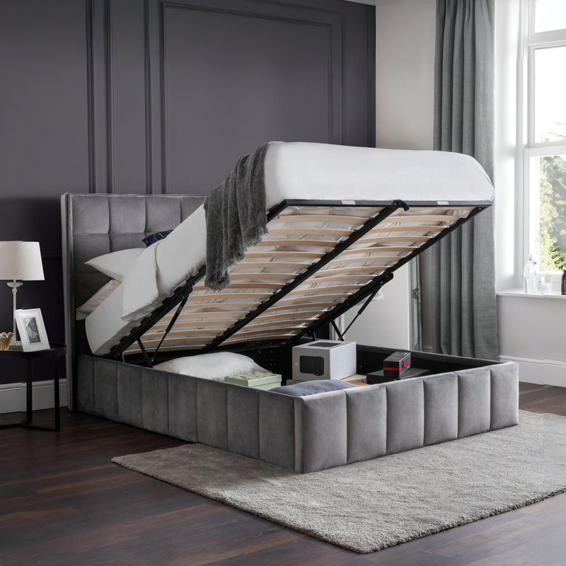 Gray upholstered bed with storage compartment in a bedroom setting