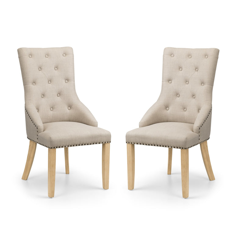 Two beige upholstered chairs with wooden legs on a white background