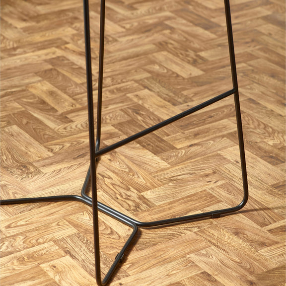 Black metal bar stool on a wooden floor