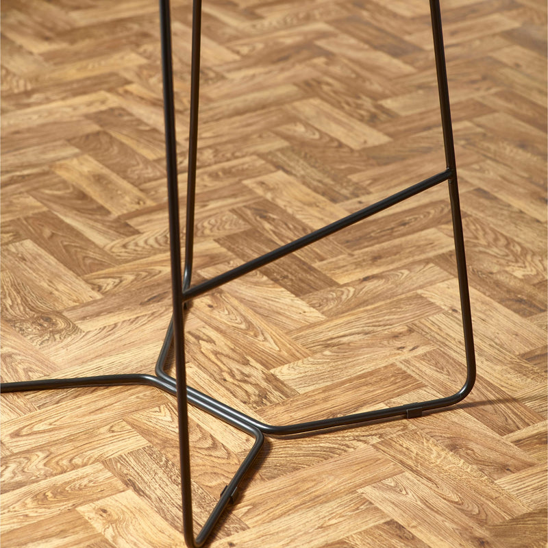 Black metal bar stool on a wooden floor