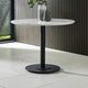 Round marble table with black base on a tiled floor