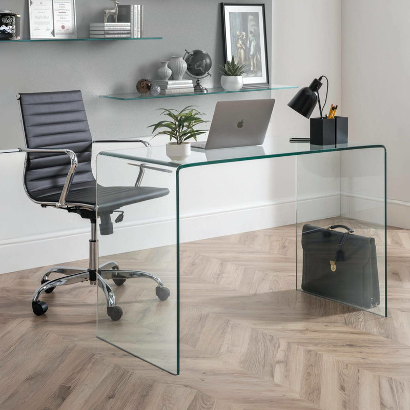 Modern office setup with a glass desk, black chair, and office items.