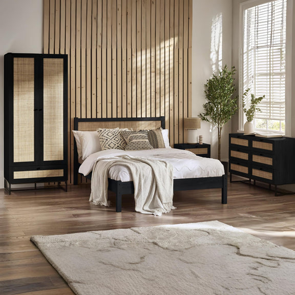 Modern bedroom with a bed, wardrobe, and side table.