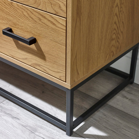 Wooden dresser with metal legs and handle on a wooden floor