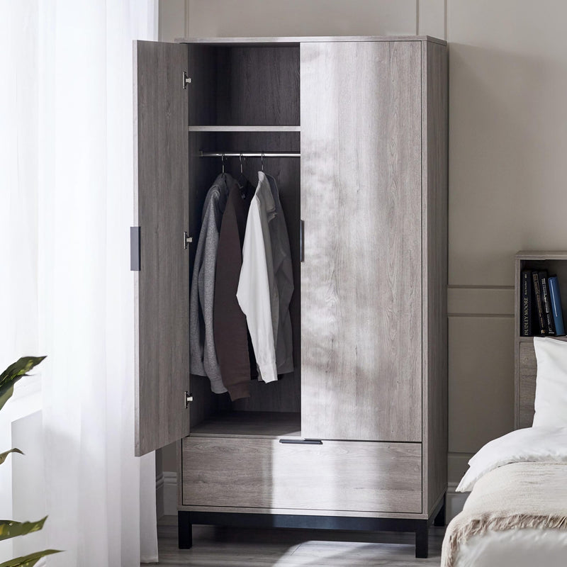 Wooden wardrobe with clothes inside in a bedroom setting
