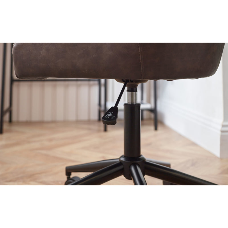 Brown office chair with black base on a wooden floor.