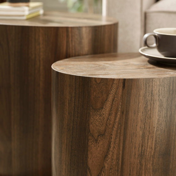 Wooden side table with a cup and saucer on a blurred background