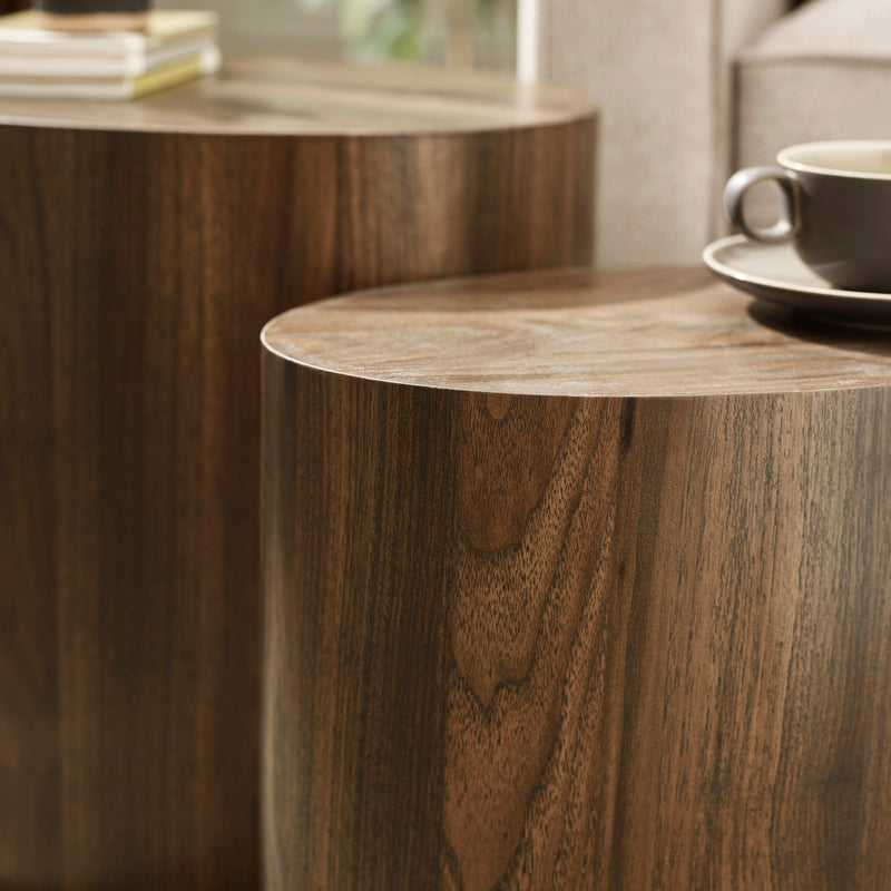 Wooden side table with a cup and saucer on a blurred background