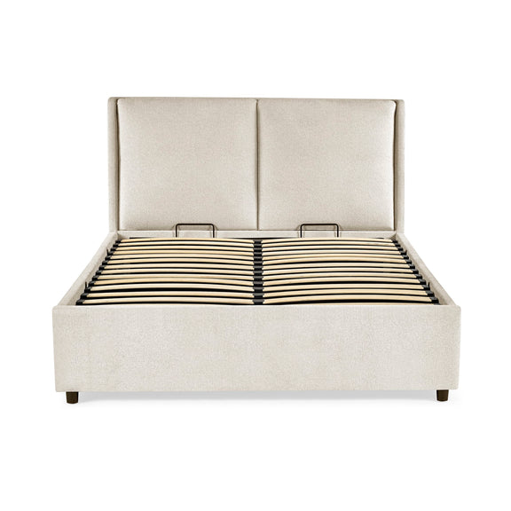 Beige upholstered bed with a white background
