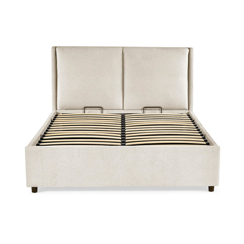 Beige upholstered bed with a white background