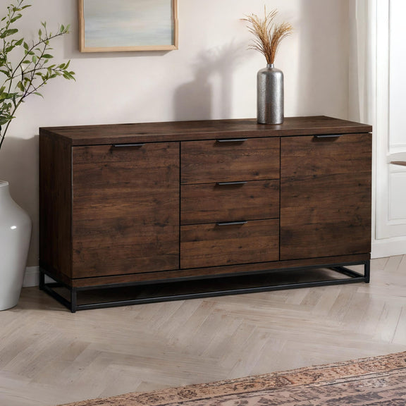 Wooden dresser with metal legs in a room setting with decor elements.