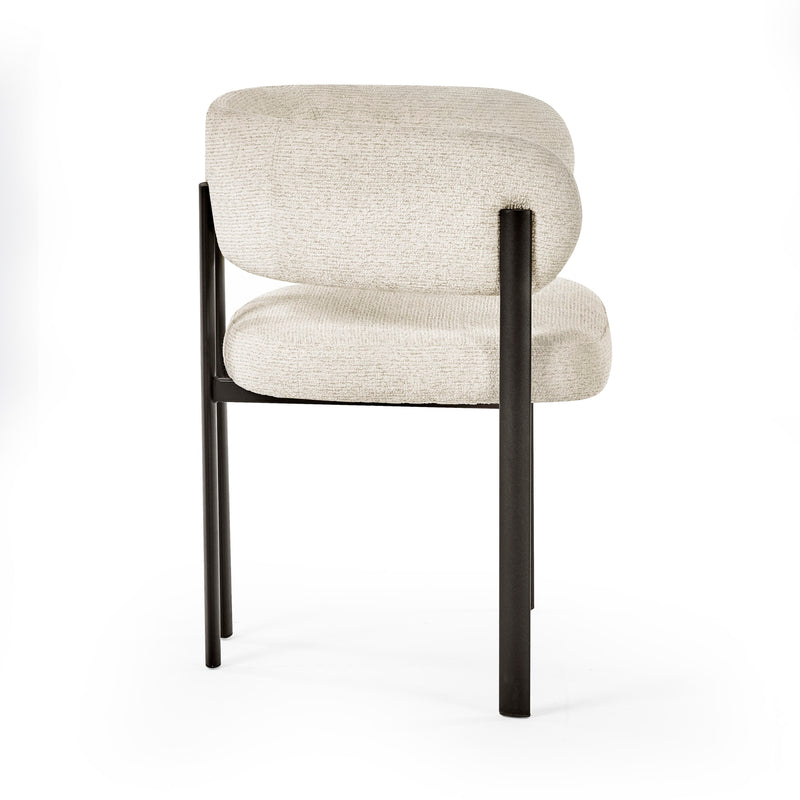 Beige upholstered chair with black metal legs on a white background