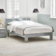 Gray bed frame with white bedding in a modern bedroom setting.