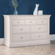 Light gray dresser with six drawers against a blue wall