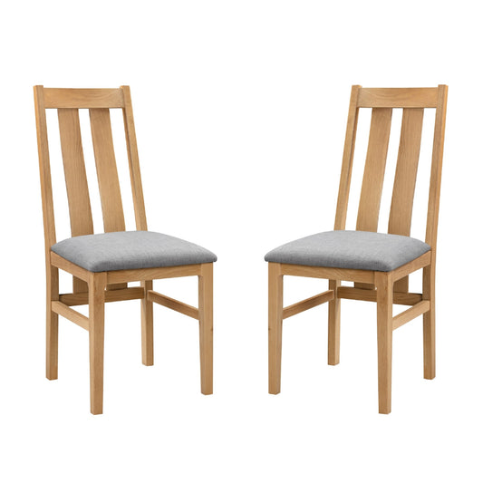 Two wooden chairs with gray cushions on a white background