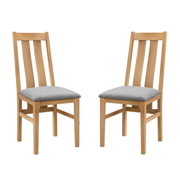 Two wooden chairs with gray cushions on a white background