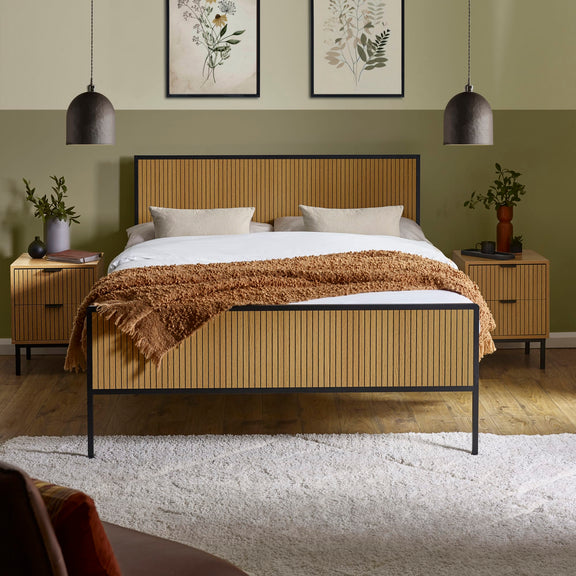 Bedroom with a wooden bed frame, white bedding, and decorative elements.
