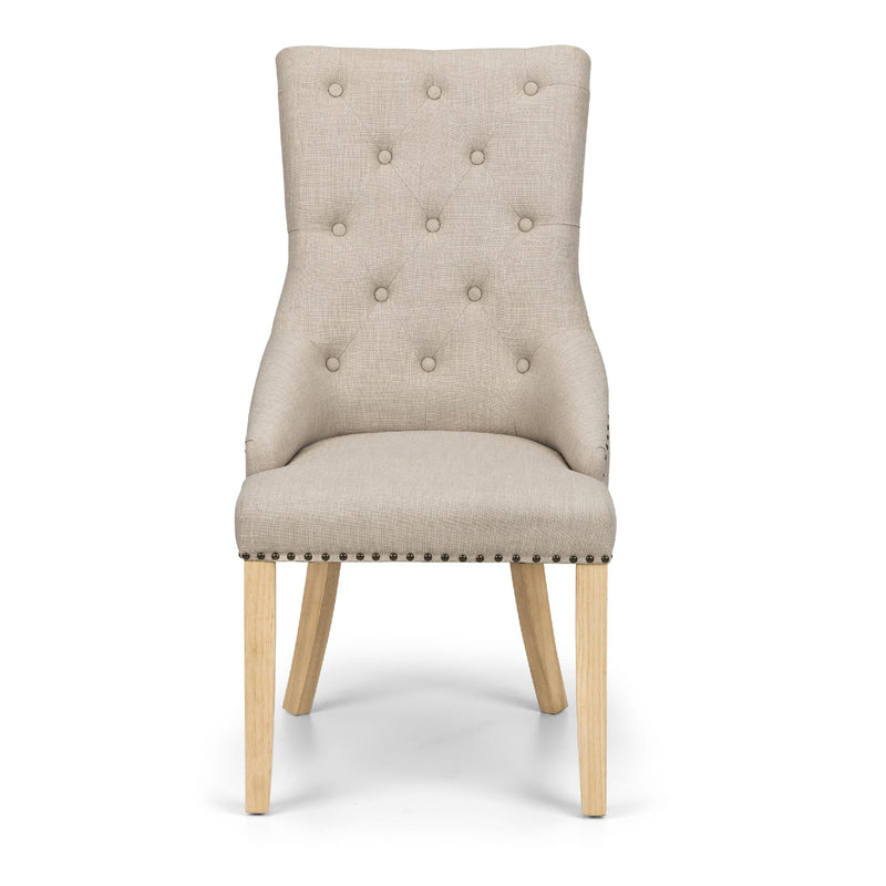 Beige upholstered chair with wooden legs on a white background