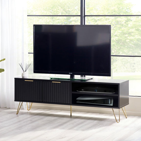Black TV stand with a flat-screen TV in a room with large windows.
