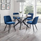 Dining room with a round glass table and four blue chairs on a wooden floor.