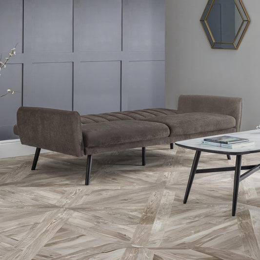 Brown sofa in a modern room with a geometric floor pattern
