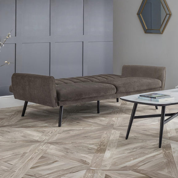 Brown sofa in a modern room with a geometric floor pattern
