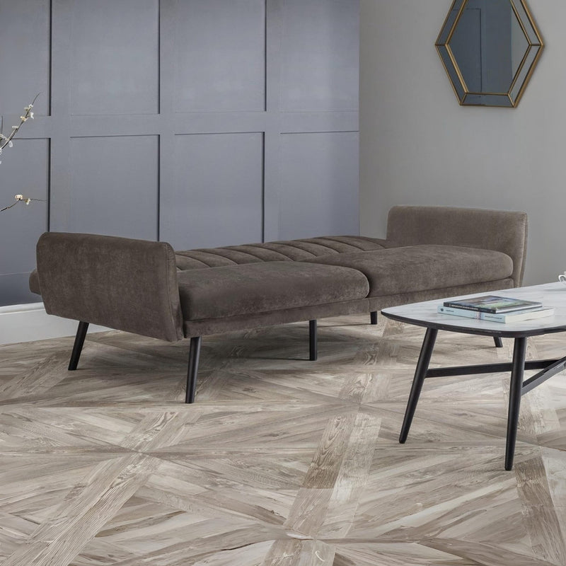 Brown sofa in a modern room with a geometric floor pattern