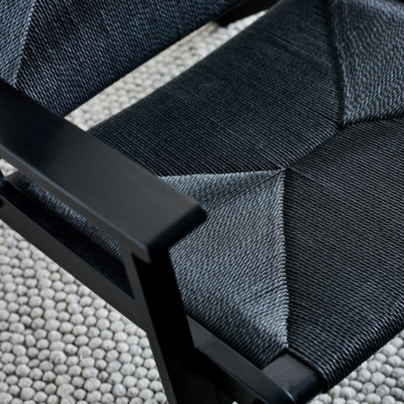 Close-up of a black strap with a textured surface on a gray background