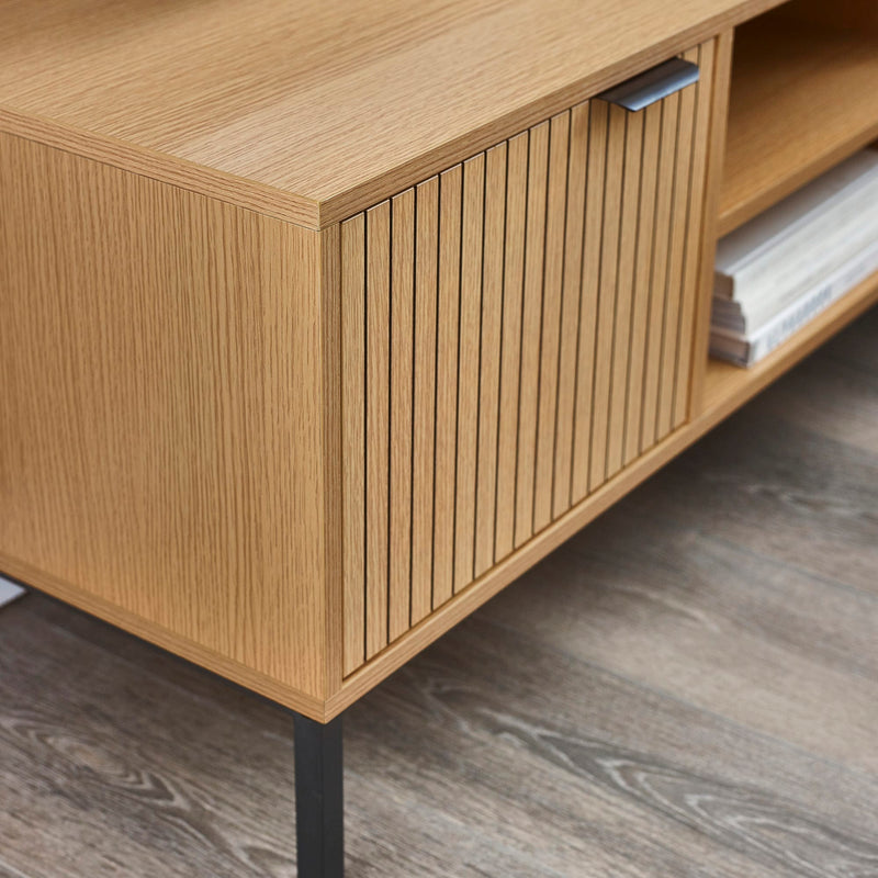 Wooden cabinet with a slatted door on a wooden floor