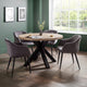 Round dining table with four gray chairs in a room with green walls and a window.