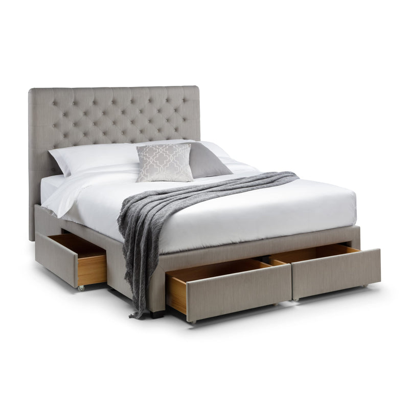 Gray upholstered bed with storage drawers on a white background