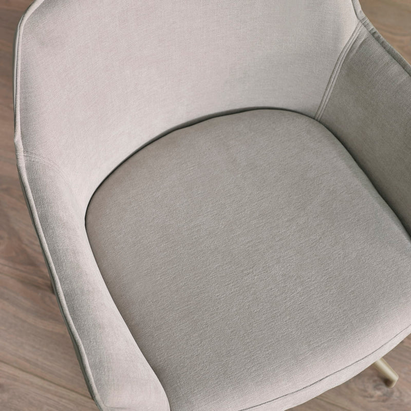 Close-up of a gray upholstered chair seat on a wooden floor.