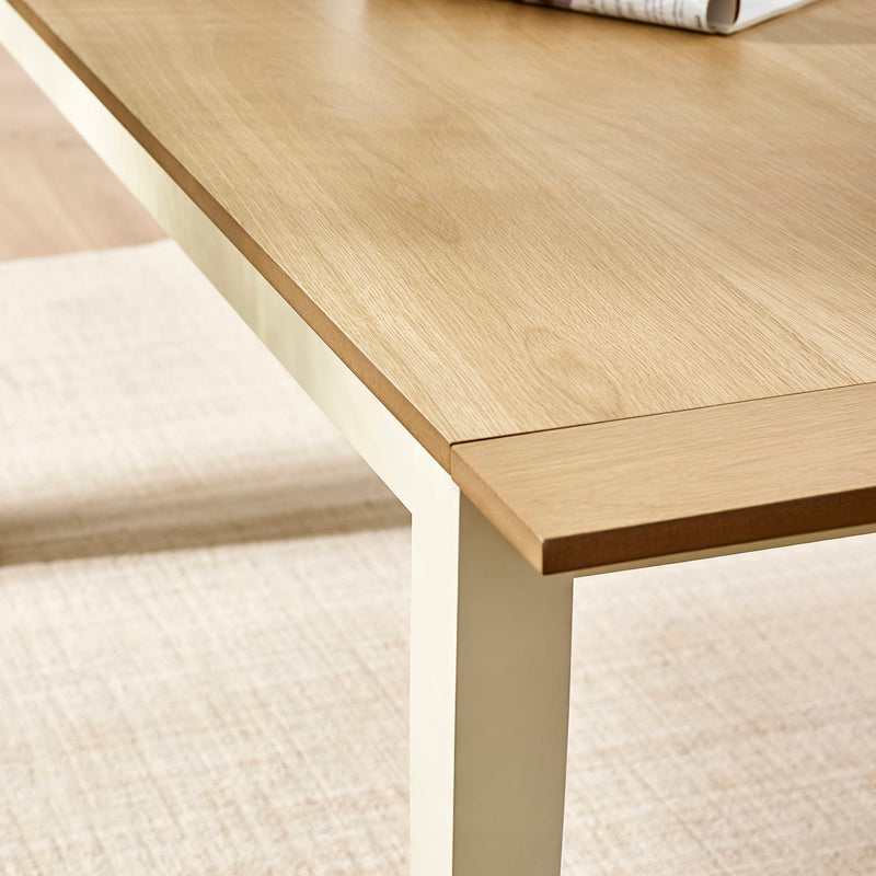 Wooden desk with a white chair on a textured beige floor