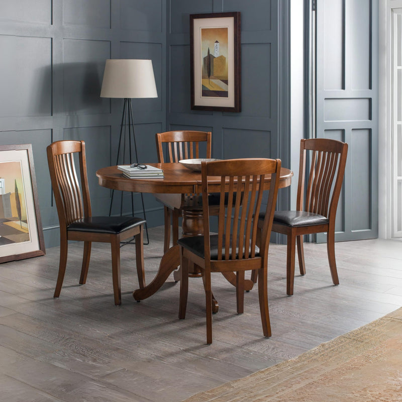 Dining room with wooden table and chairs against a gray paneled wall.