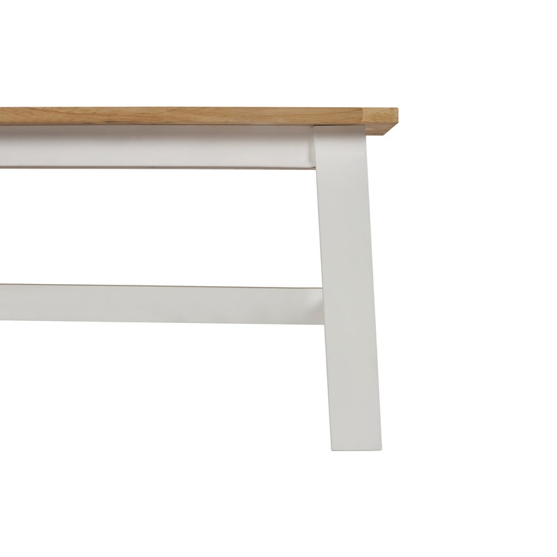 Close-up of a wooden and white baseboard on a white background