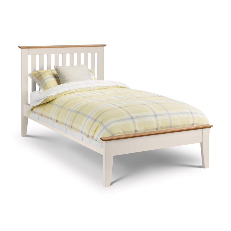 White bed with yellow plaid bedding on a white background