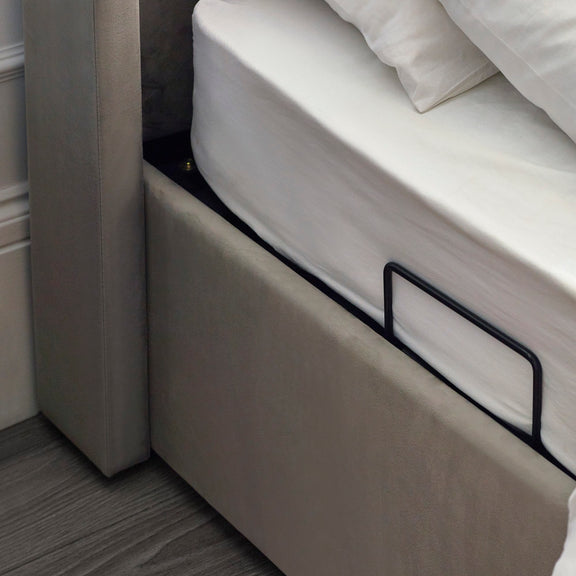 Close-up of a bed with a mattress and headboard in a room.