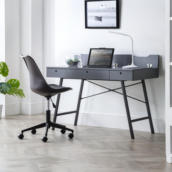 Modern office desk with chair and laptop in a bright room