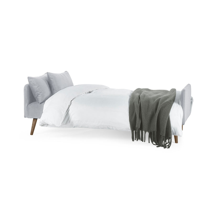 Gray bed with white bedding and a green throw blanket on a white background