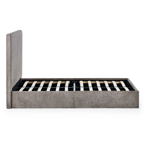 Gray upholstered bed frame with striped mattress on a white background