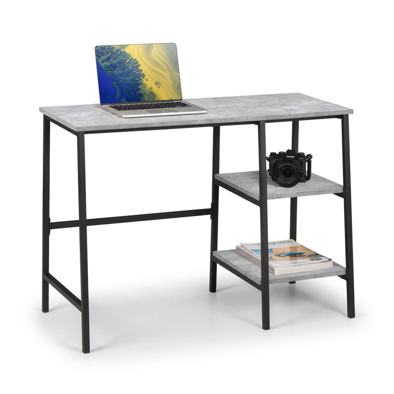 Small desk with a laptop, camera, and books on a white background