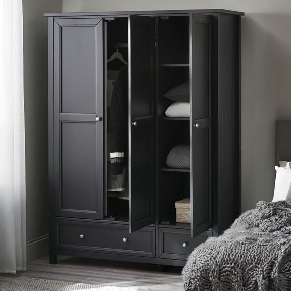 Black wardrobe with open doors in a room setting
