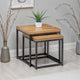 Nest of two wooden tables with metal legs against a gray wall.