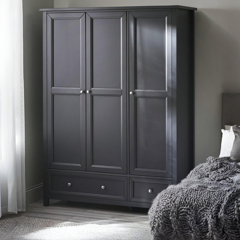 Dark gray wardrobe in a bedroom with a bed and curtains.