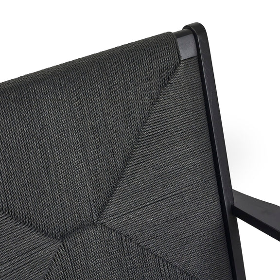 Close-up of a gray textured chair backrest with black metal frame.