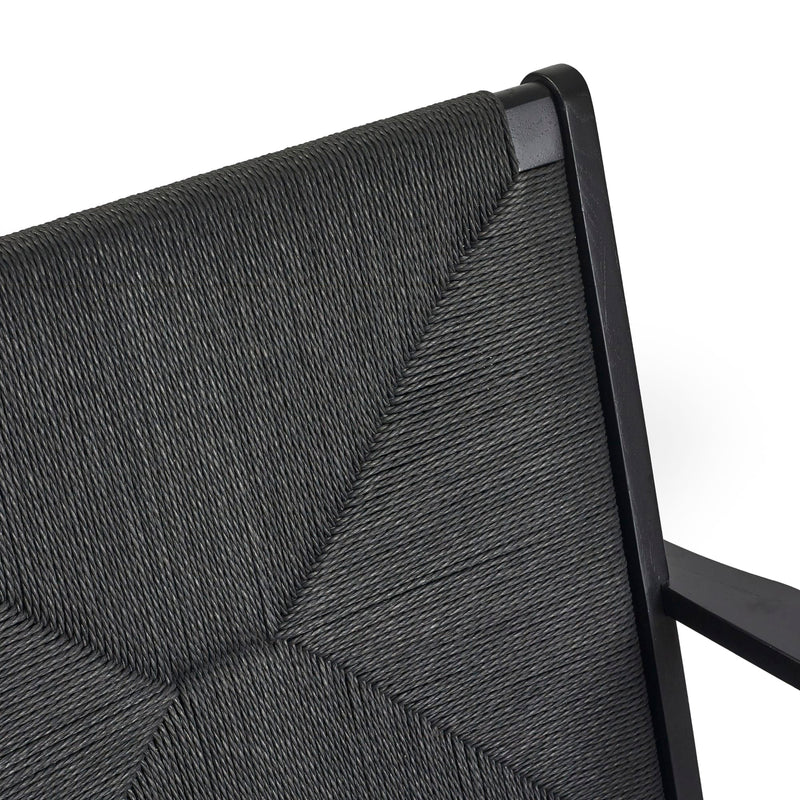 Close-up of a gray textured chair backrest with black metal frame.