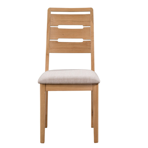 Wooden chair with a beige cushion on a white background