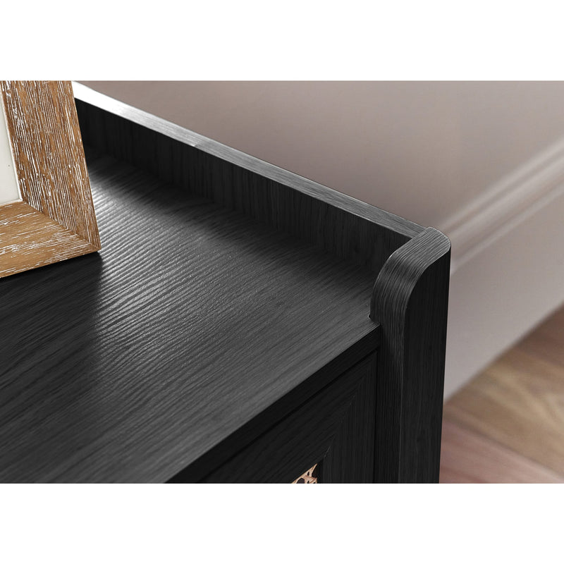 Close-up of a black wooden shelf with a white wall in the background