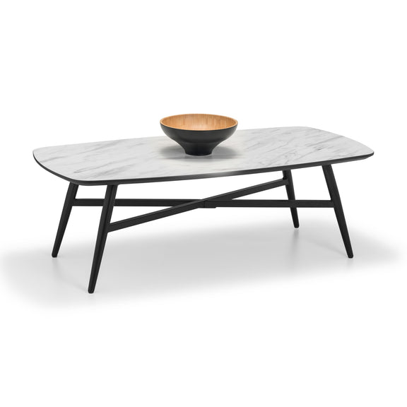 Coffee table with marble top and black legs on a white background